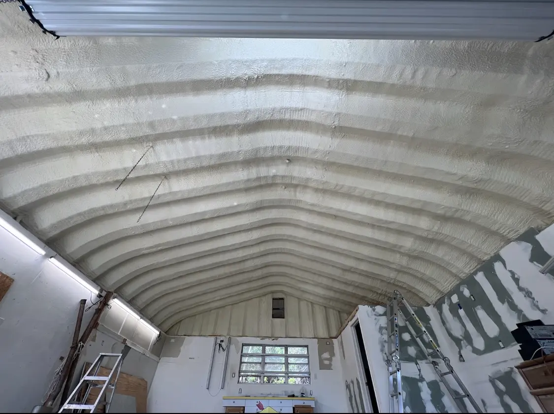 Spray polyurethane foam applied to the underside of a metal roof deck in Kennett